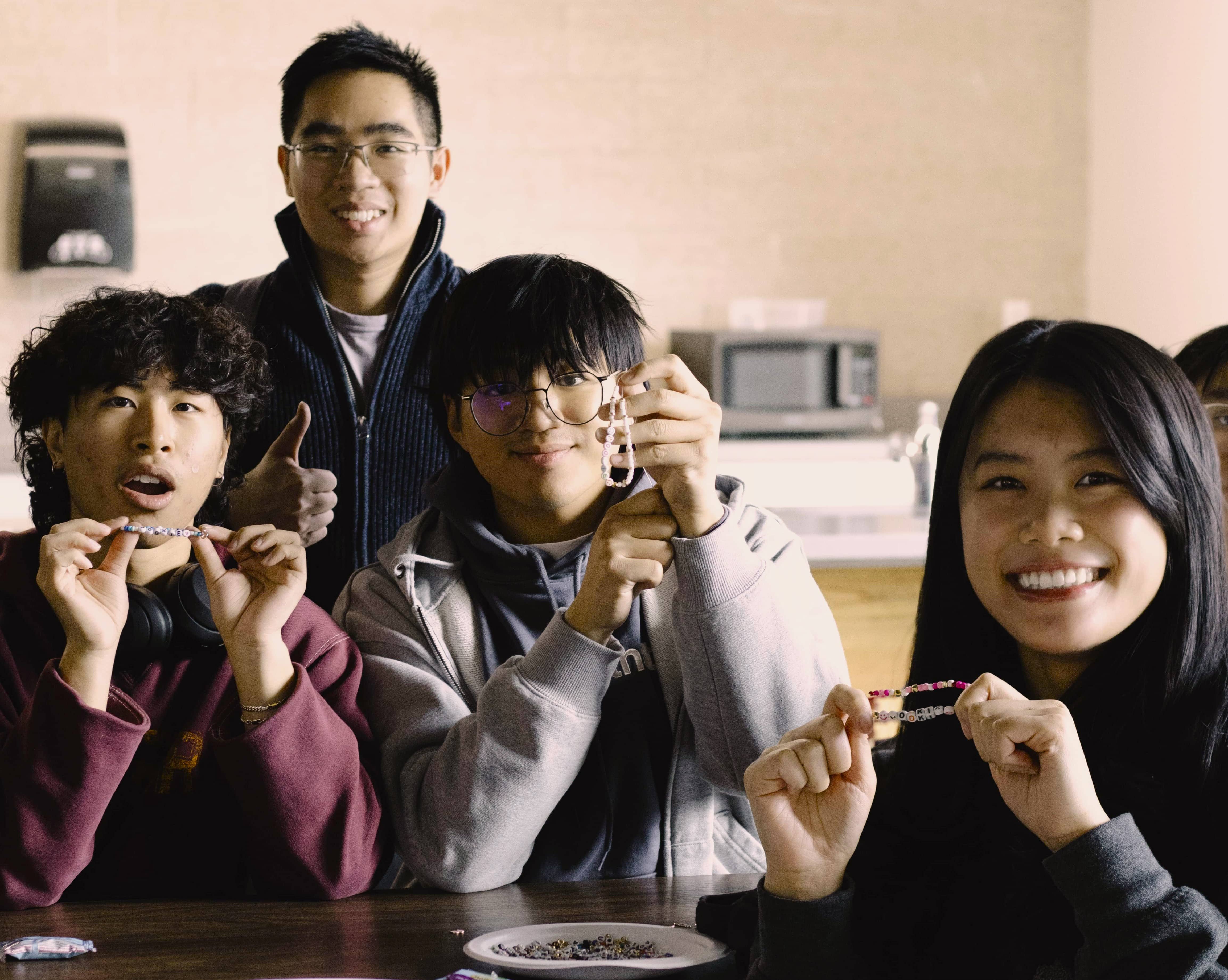 group of students holding up bracelets