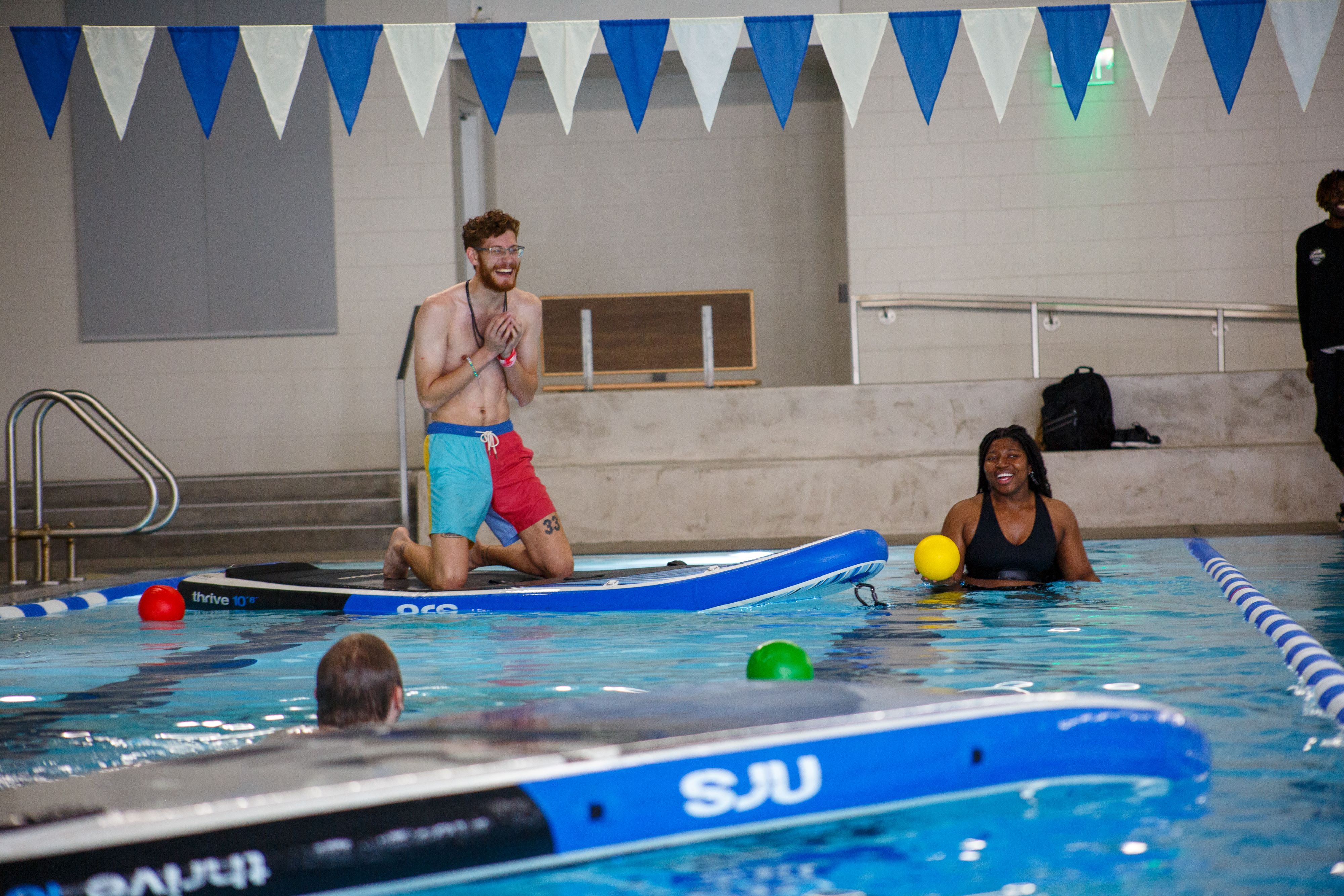 Students playing Dodgeball on stand up paddle boards