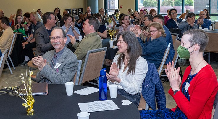 Celebration of Faculty Excellence attendees applauding