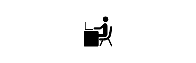 Icon of human figure sitting at a desk working on a laptop