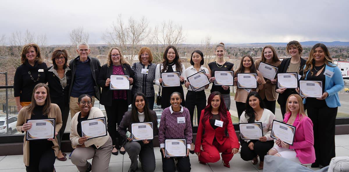 Empowering Women in Business program participants holding their certificates, smiling in an outdoor setting.