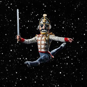 Nutcracker ballet dancer mid-jump in Nutcracker costume, black starry sky background.