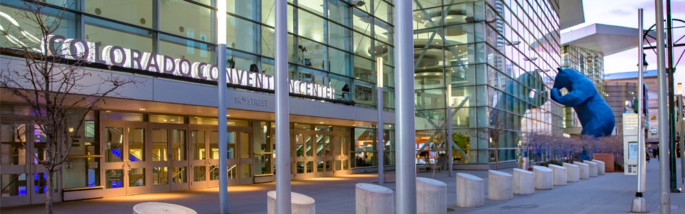 Street view of Colorado Convention Center with Big Blue Bear looking through the window