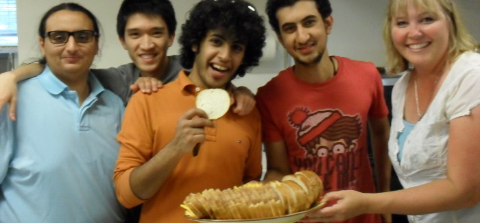students posing with bread