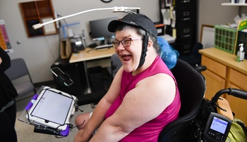a woman smiles from her wheelchair