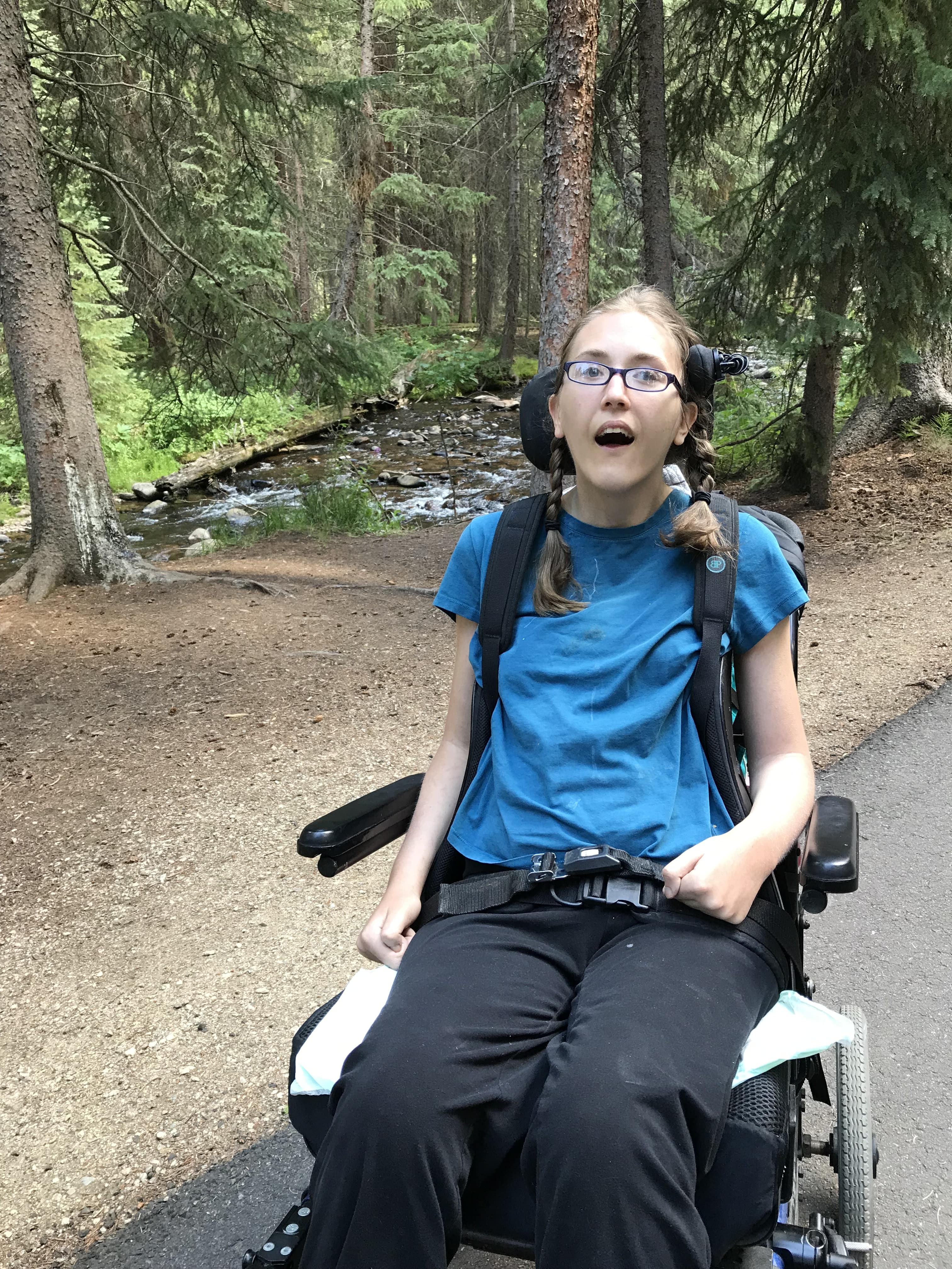 Woman in wheelchair hiking on hiking trail