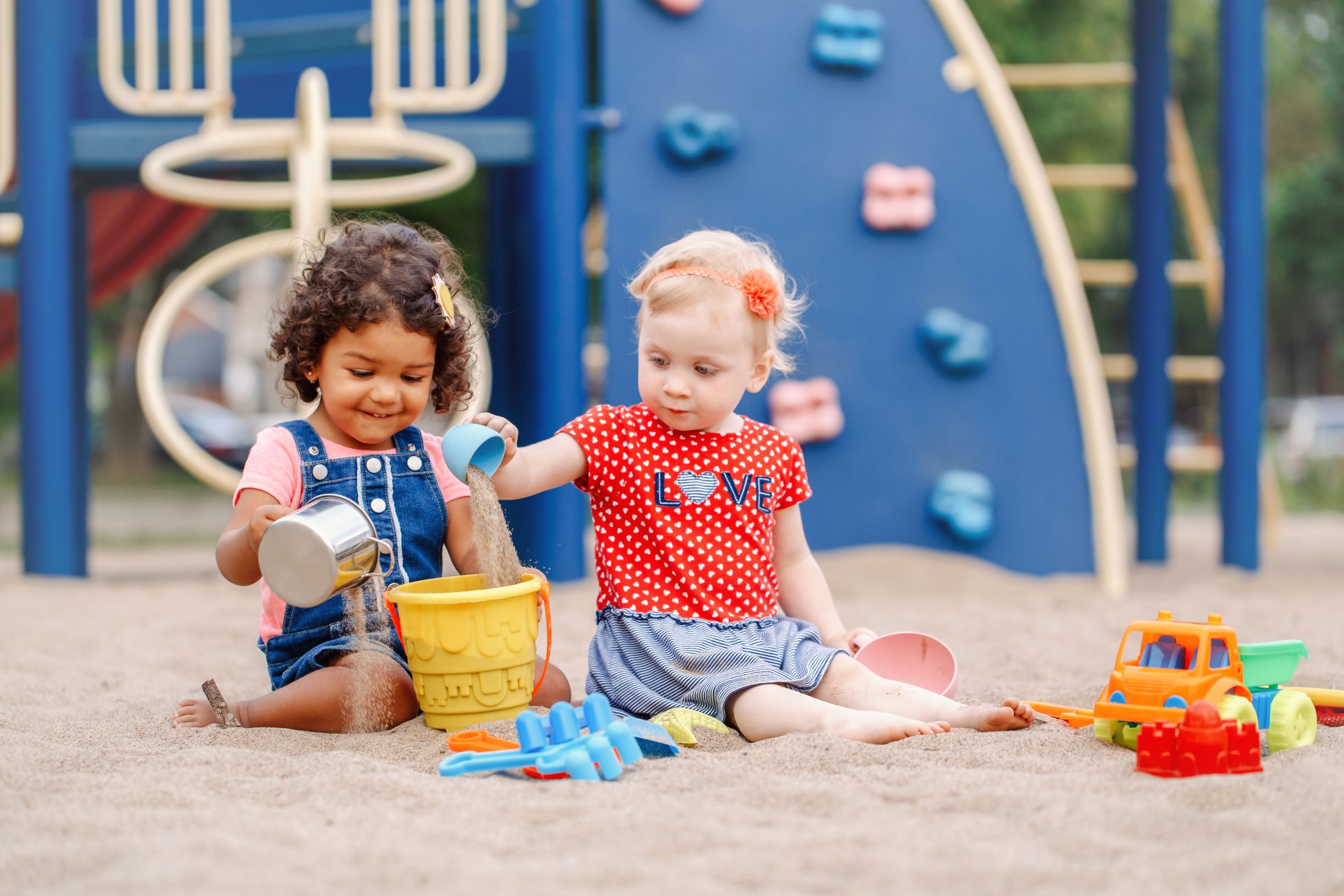 Little girls playing in sand v2