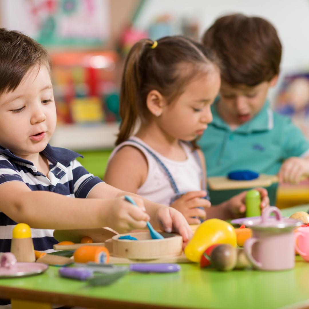 Preschool children playing with toys at a table