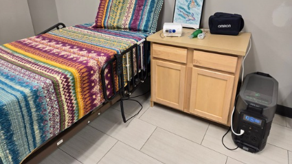 A hospital bed and nebulizer are plugged into an emergency backup battery