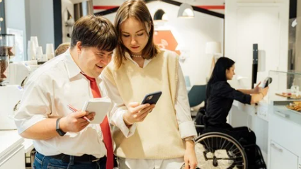 People with various disabilities engage with smartphones and tablets