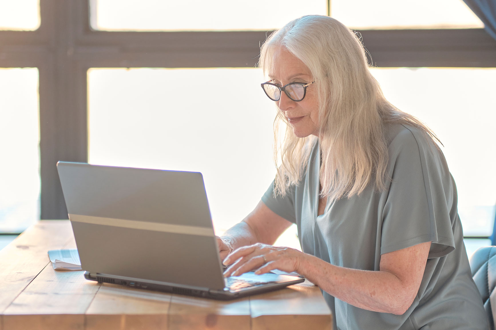 Older woman works at laptop