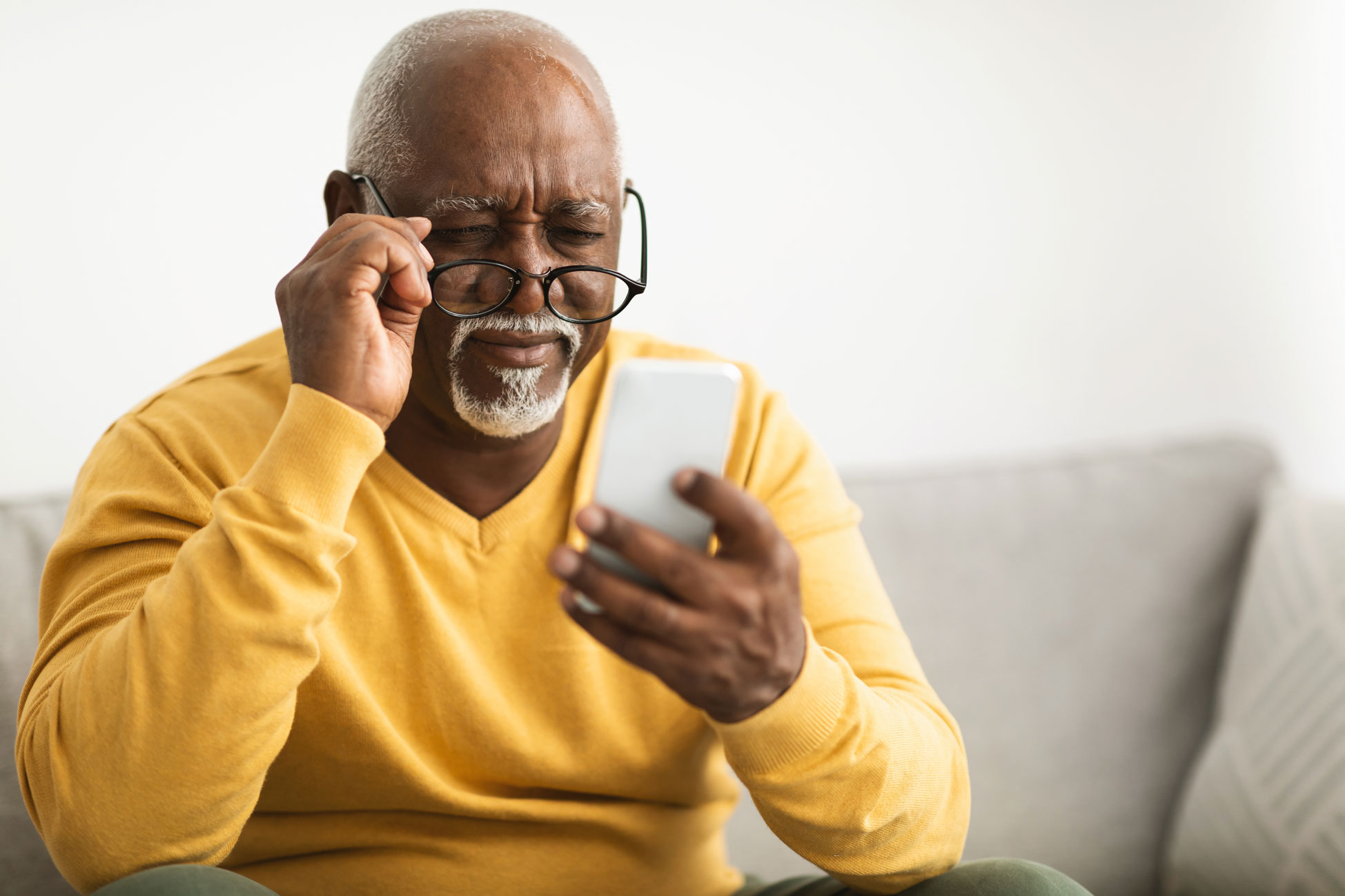 Older man struggles to see phone
